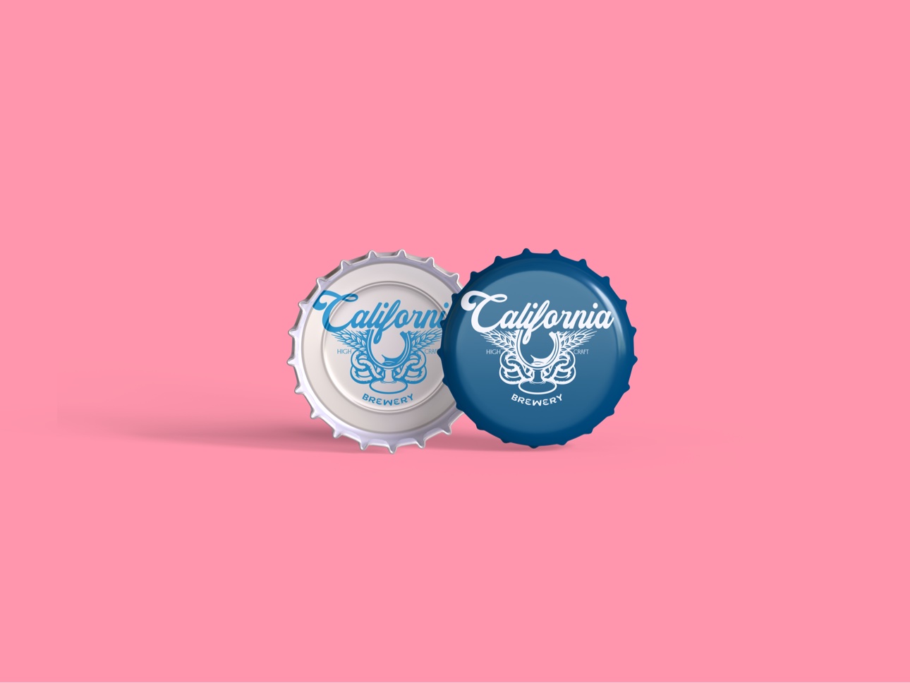 California Brewery logo printed on two bottle caps — blue on silver and white on navy — against a pink background